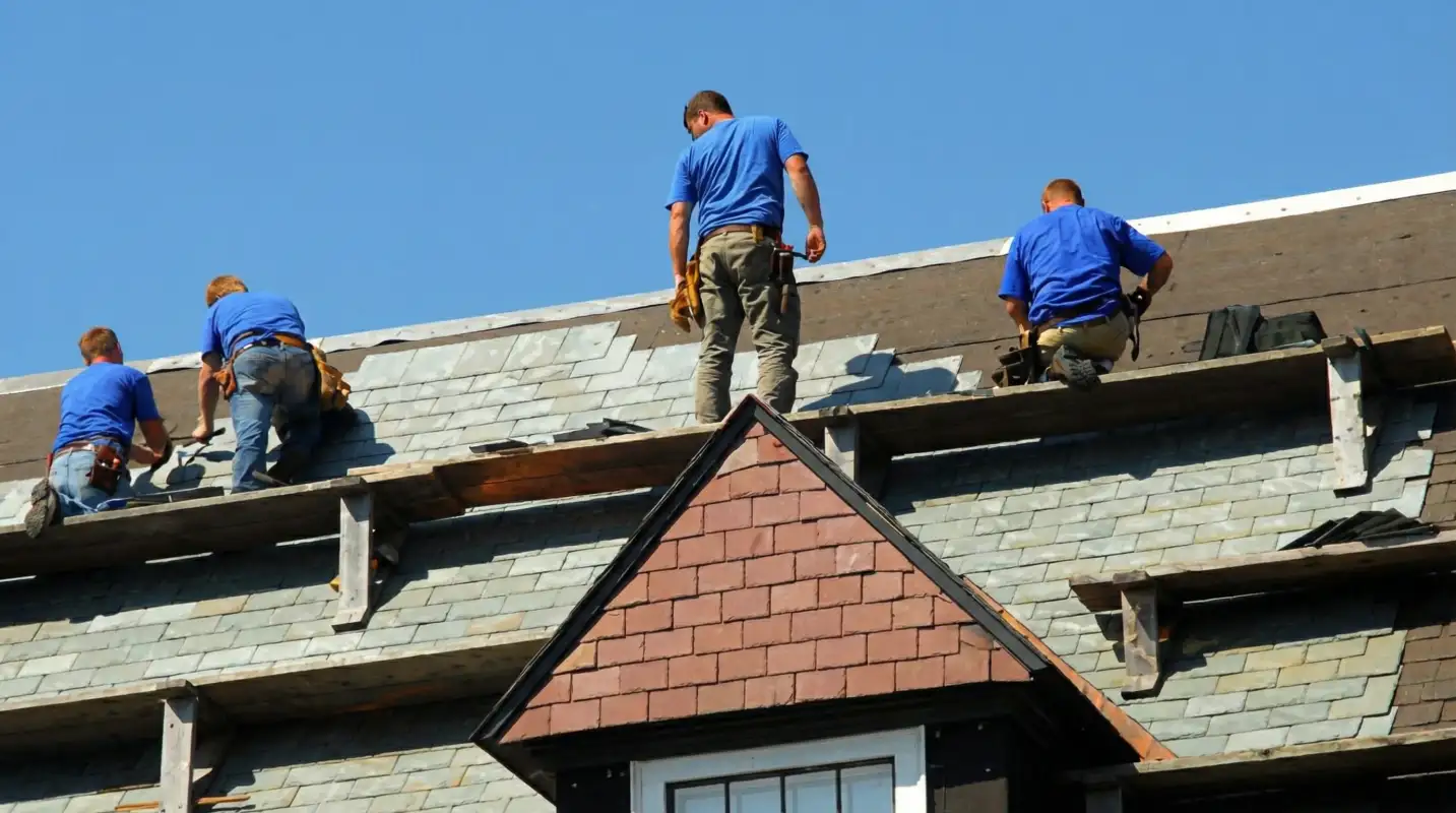 Roof replacement in progress with a team of professional contractors installing new shingles on a residential home in Tucson, AZ