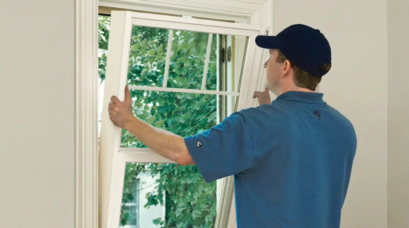 Professional contractors performing a residential window insulation and replacement service in Tucson, AZ